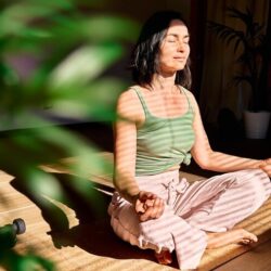 woman-practicing-yoga-meditation-home-sitting-lotus-pose-relaxed-with-closed-eyes_1048944-22255920